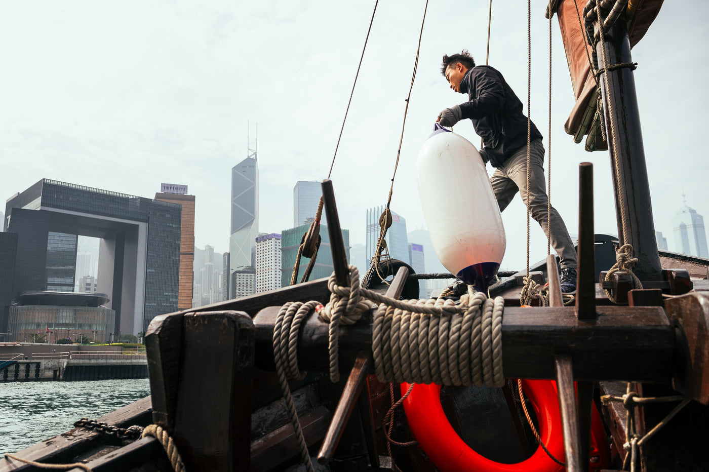 Boat Fender carried by man on Junk Boat in Victoria Harbour, Hong Kong