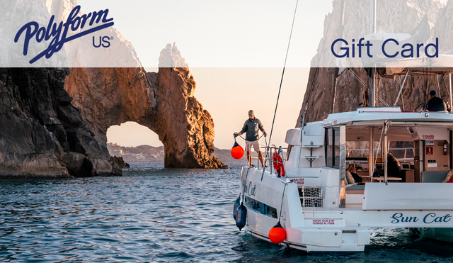 Boat fenders and buoys in use on a catamaran yacht in a rocky sea cove in Baja, Mexico