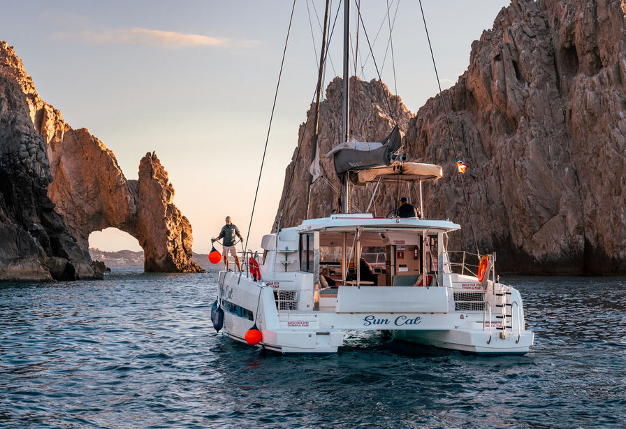 Boat fenders and buoys in use on a yacht in a rocky sea cove in Baja, Mexico