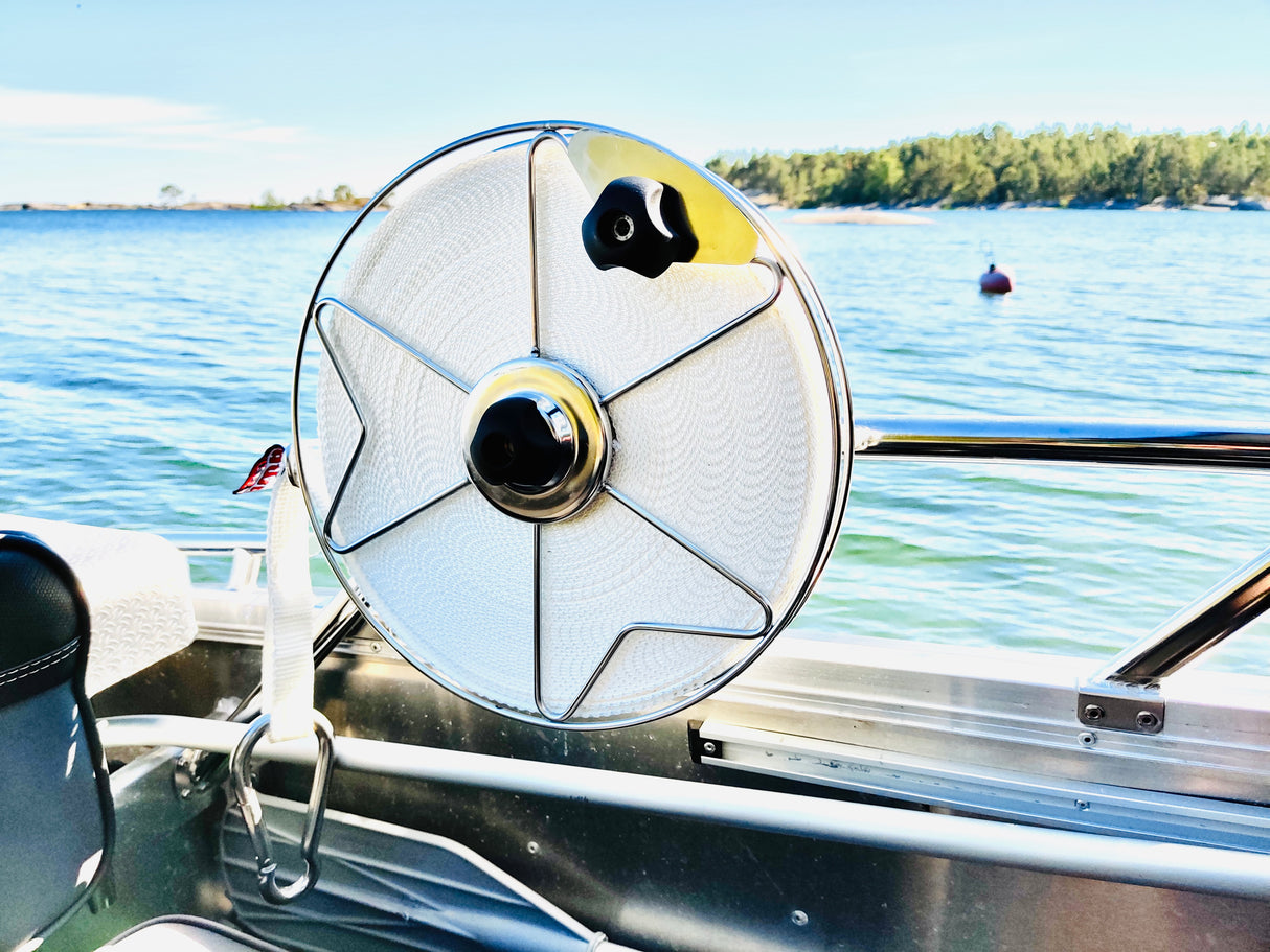 Stainless steel mooring reel with one inch polyester flat line, attached to boat railing